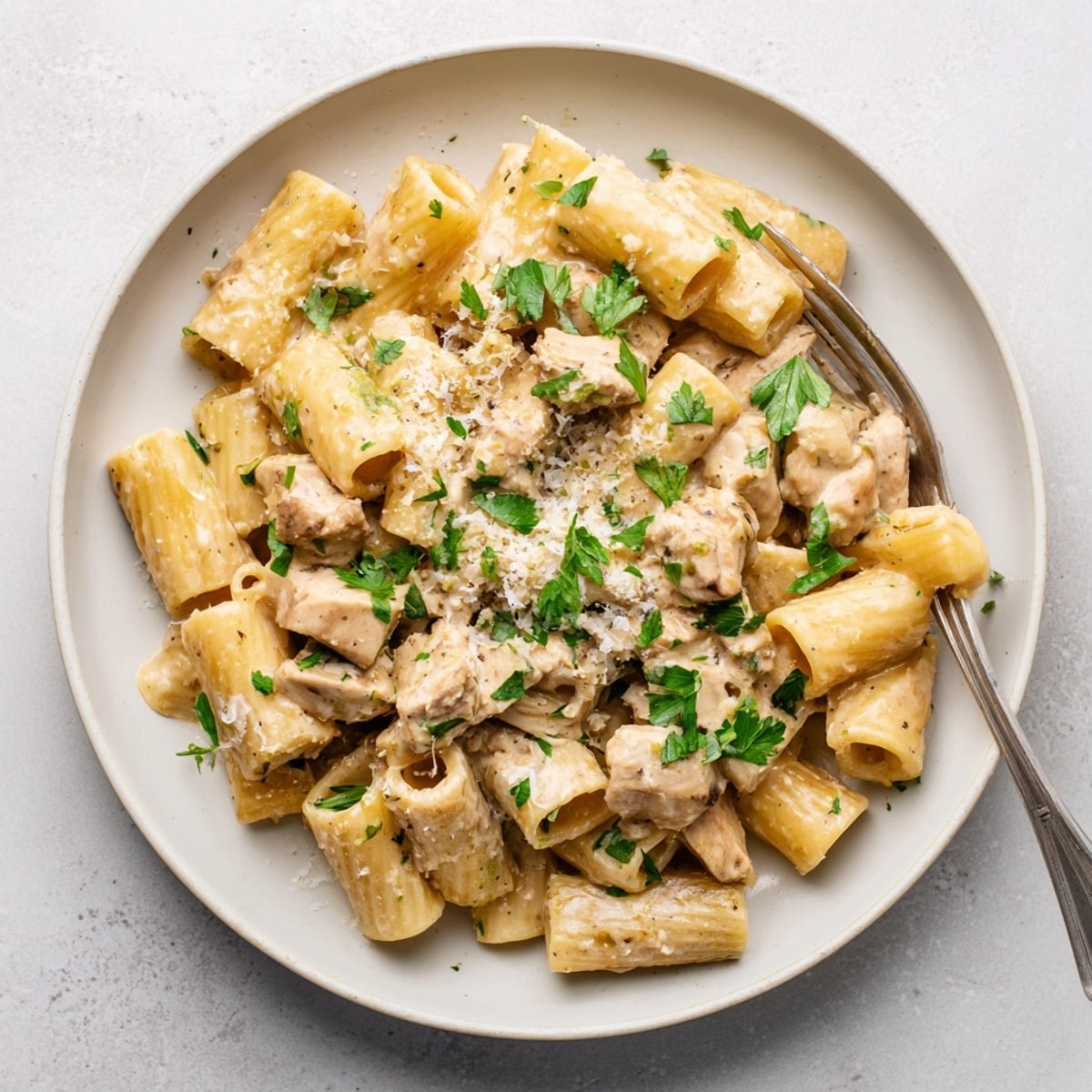 Overhead shot of Creamy Garlic Parmesan Chicken Rigatoni in a skillet, a cozy weeknight dinner.