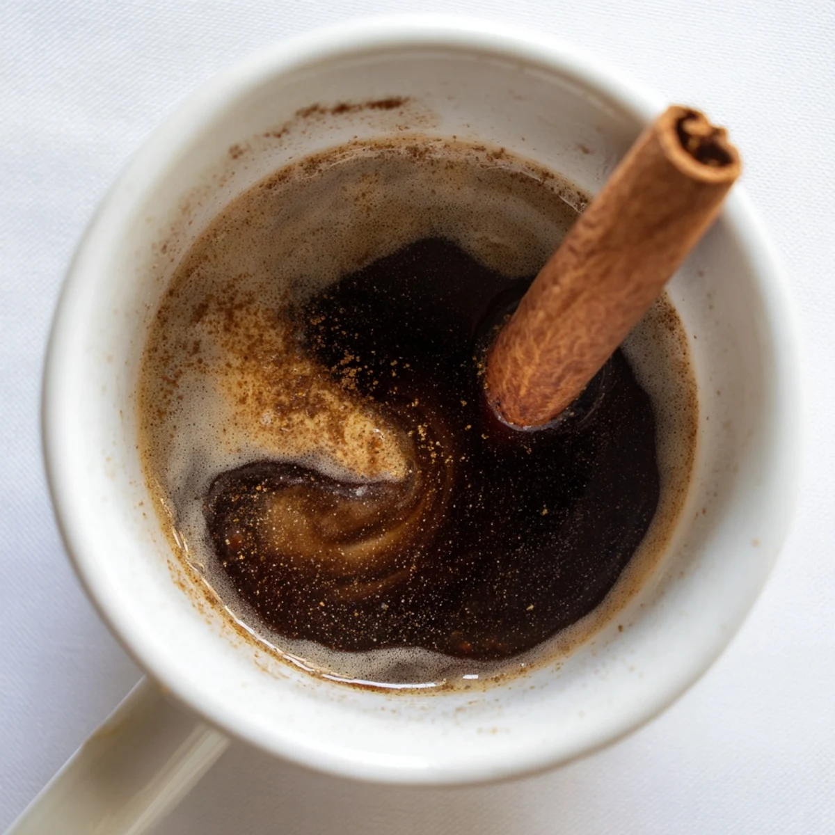 Steaming mug of Spiced Coffee, infused with cinnamon and cloves, ready to warm you.
