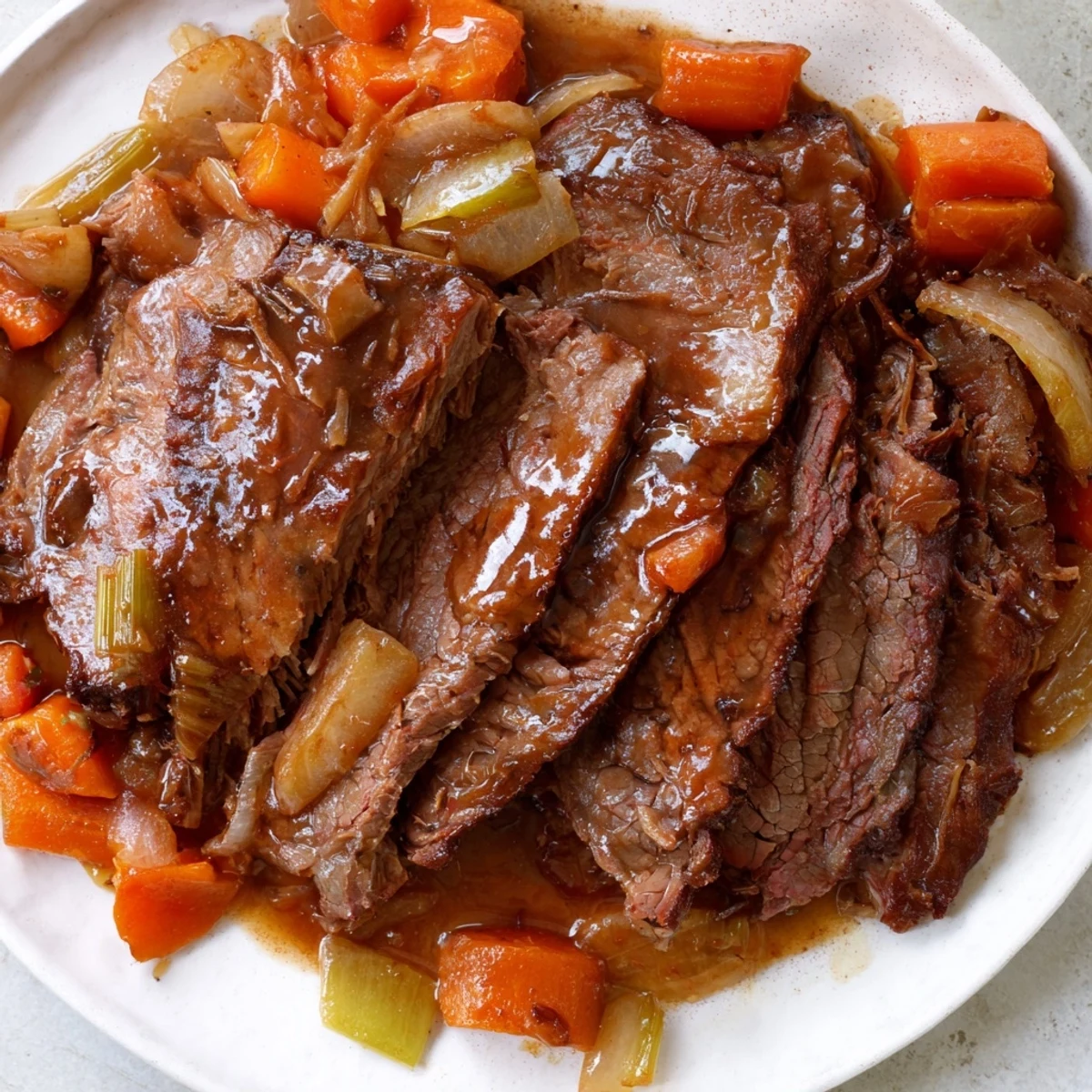 Plate of perfectly sliced slow cooked beef brisket, a classic American comfort food meal.