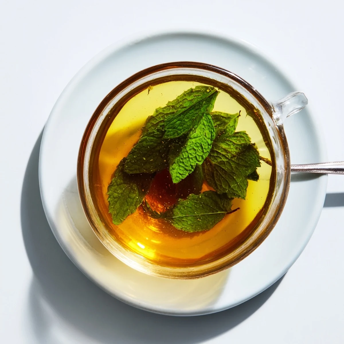Fragrant mint tea, a warm, inviting beverage, perfect for a relaxing afternoon treat with friends.