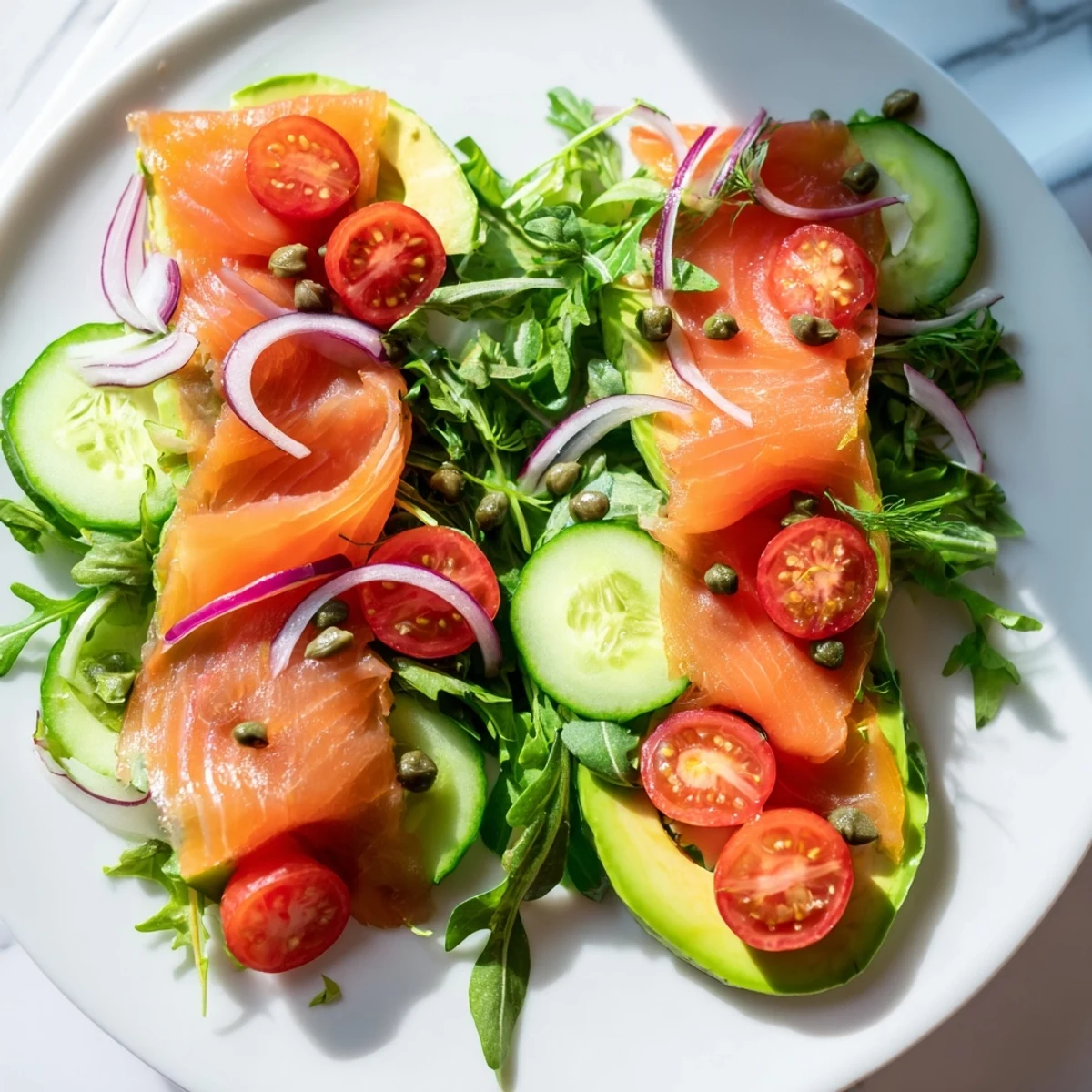 A beautifully plated Smoked Salmon Salad, showcasing flaky salmon atop a bed of crisp greens and ripe avocado slices.