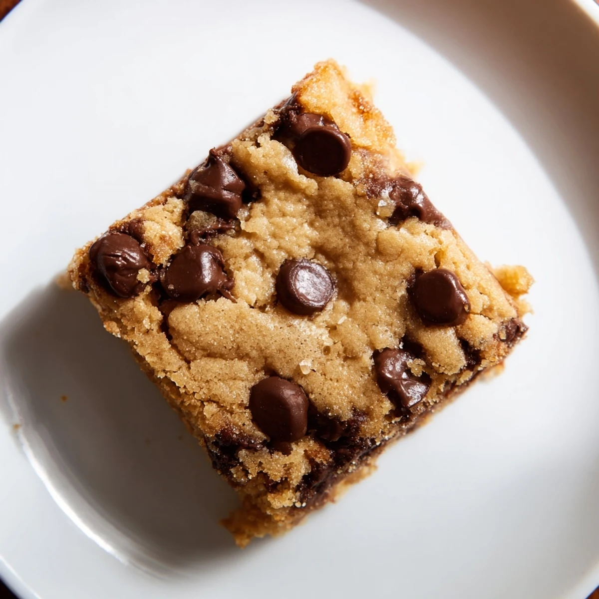 Perfectly baked chocolate chip cookie bars, showcasing a generous amount of chocolate chips throughout.