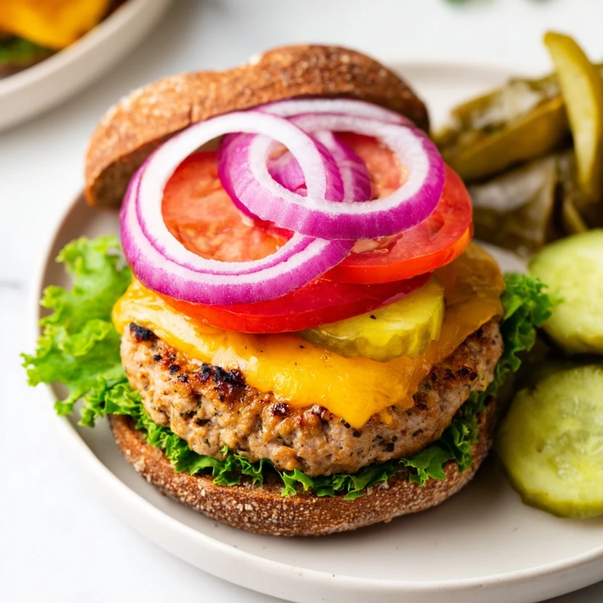 A close-up of a flavorful turkey burger and baked sweet potato fries, perfect for dinner.