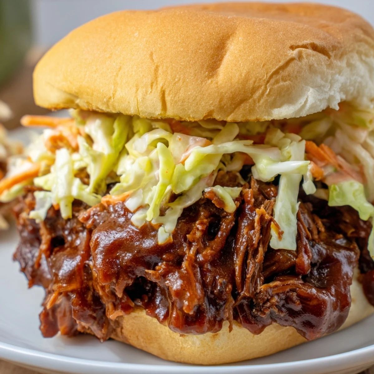 Slow Cooker Pulled Beef Sandwiches served with tangy coleslaw, perfect for a family barbecue dinner.