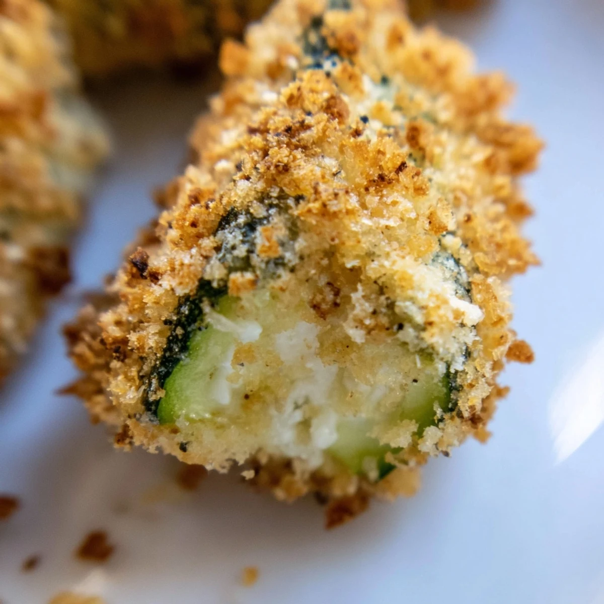 Golden Crispy Zucchini Fries fresh from the oven, paired with garlic aioli for a flavorful snack.