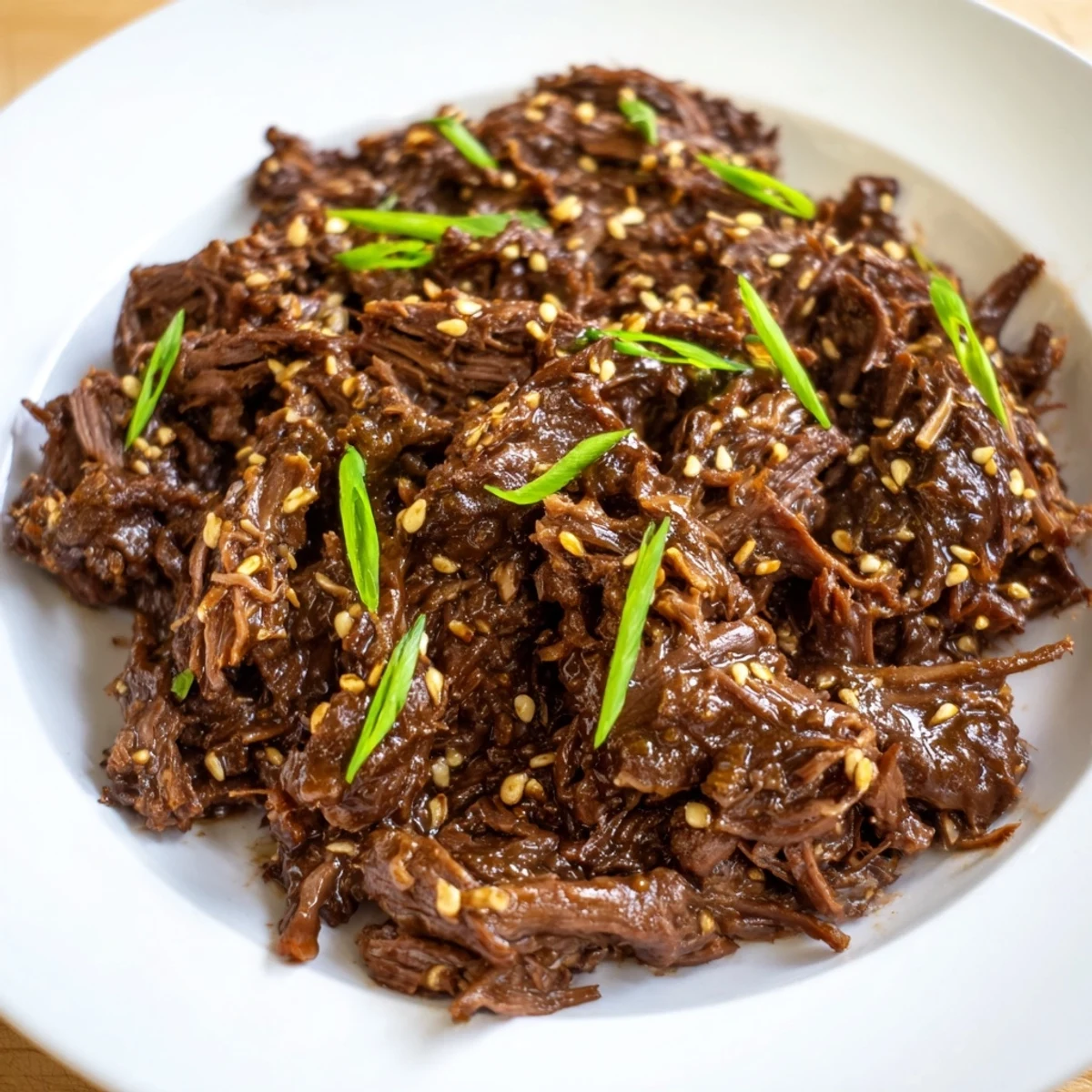 Slow Cooker Korean Beef in a lettuce wrap, ready to serve with fresh garnishes and rice