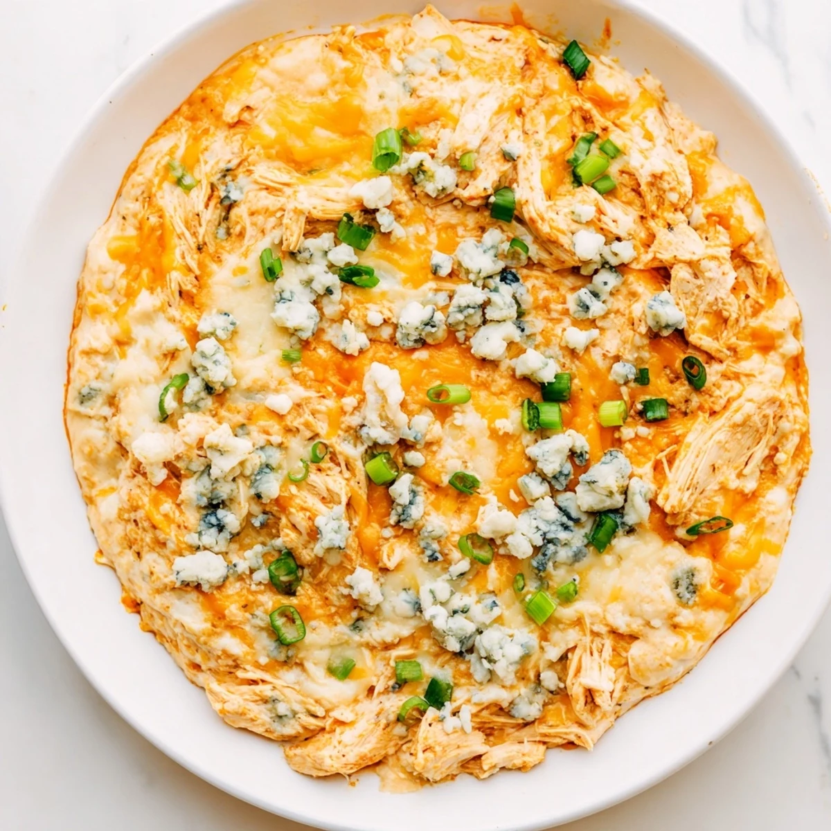 A platter of Keto Buffalo Chicken Dip with celery sticks and keto crackers, ready for a low-carb game day snack.