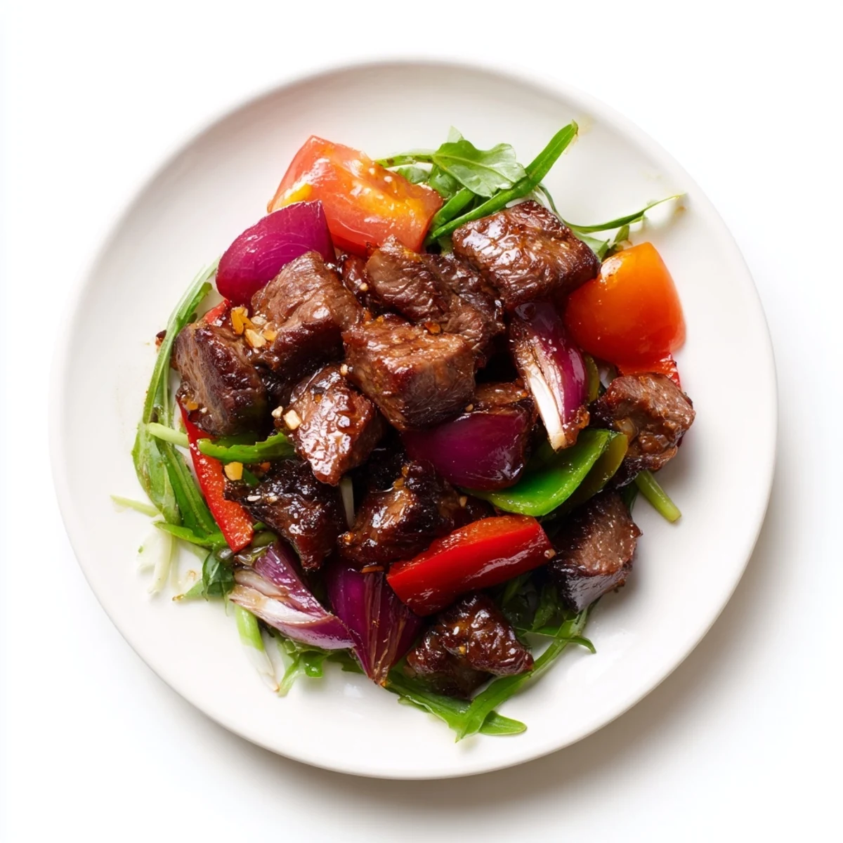 Juicy Vietnamese Shaking Beef stir-fry with colorful bell peppers and onions, served over fluffy jasmine rice for a weeknight dinner.