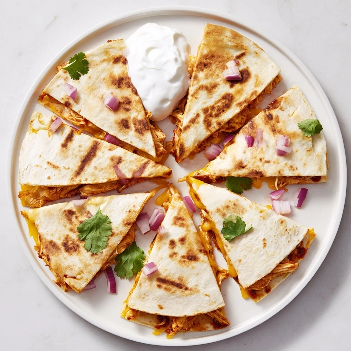 Golden-brown Hot Honey BBQ Chicken Quesadillas on a cutting board, sliced into wedges and served with fresh lime wedges.
