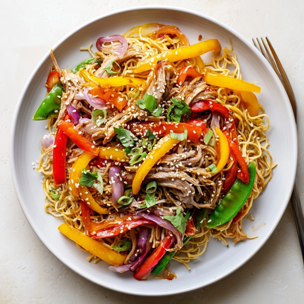 A plated bowl of Sweet Chilli Turkey Noodle Stir Fry, ready to serve with fresh spring onions and coriander.