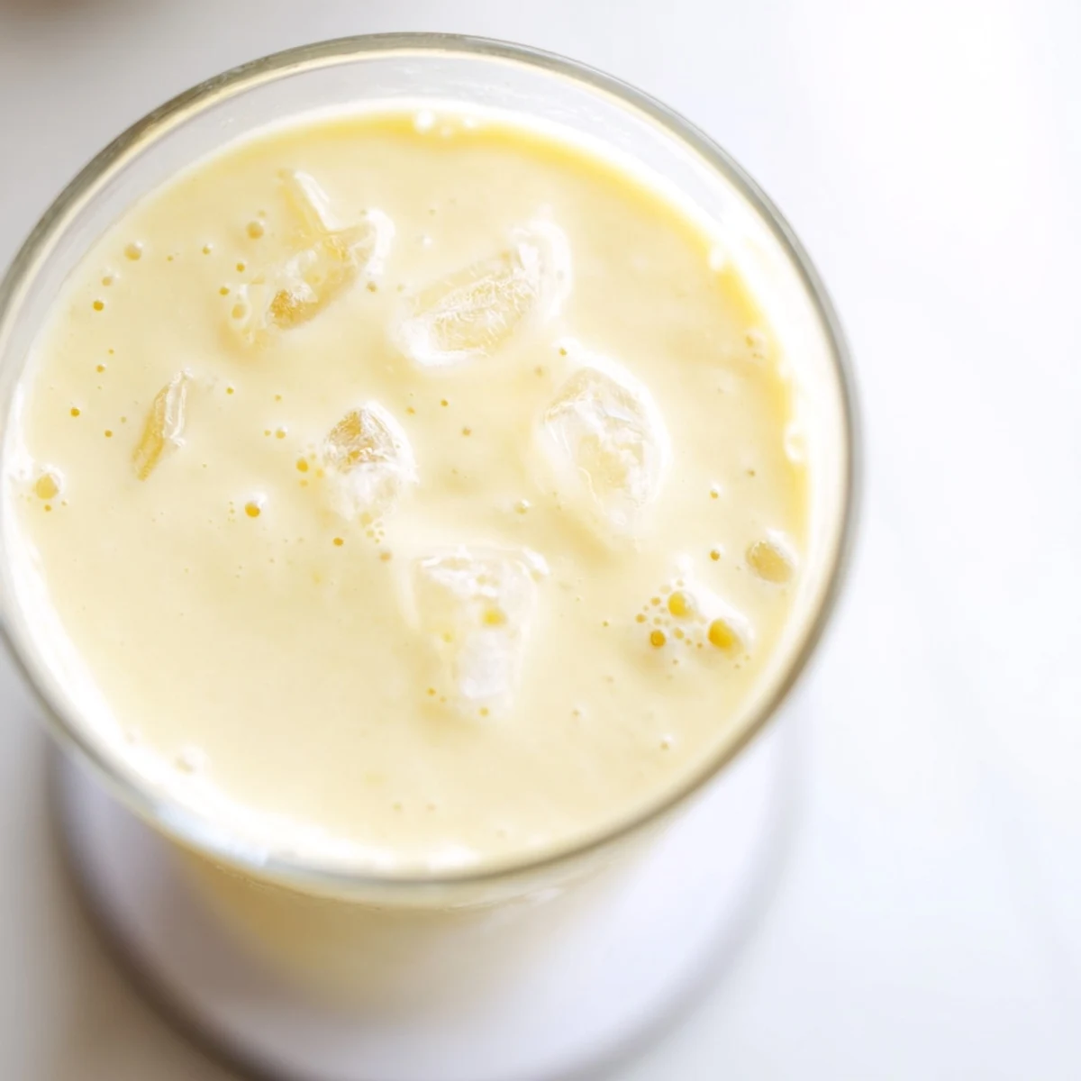 Creamy durian smoothie blended with banana and coconut milk in a chilled glass