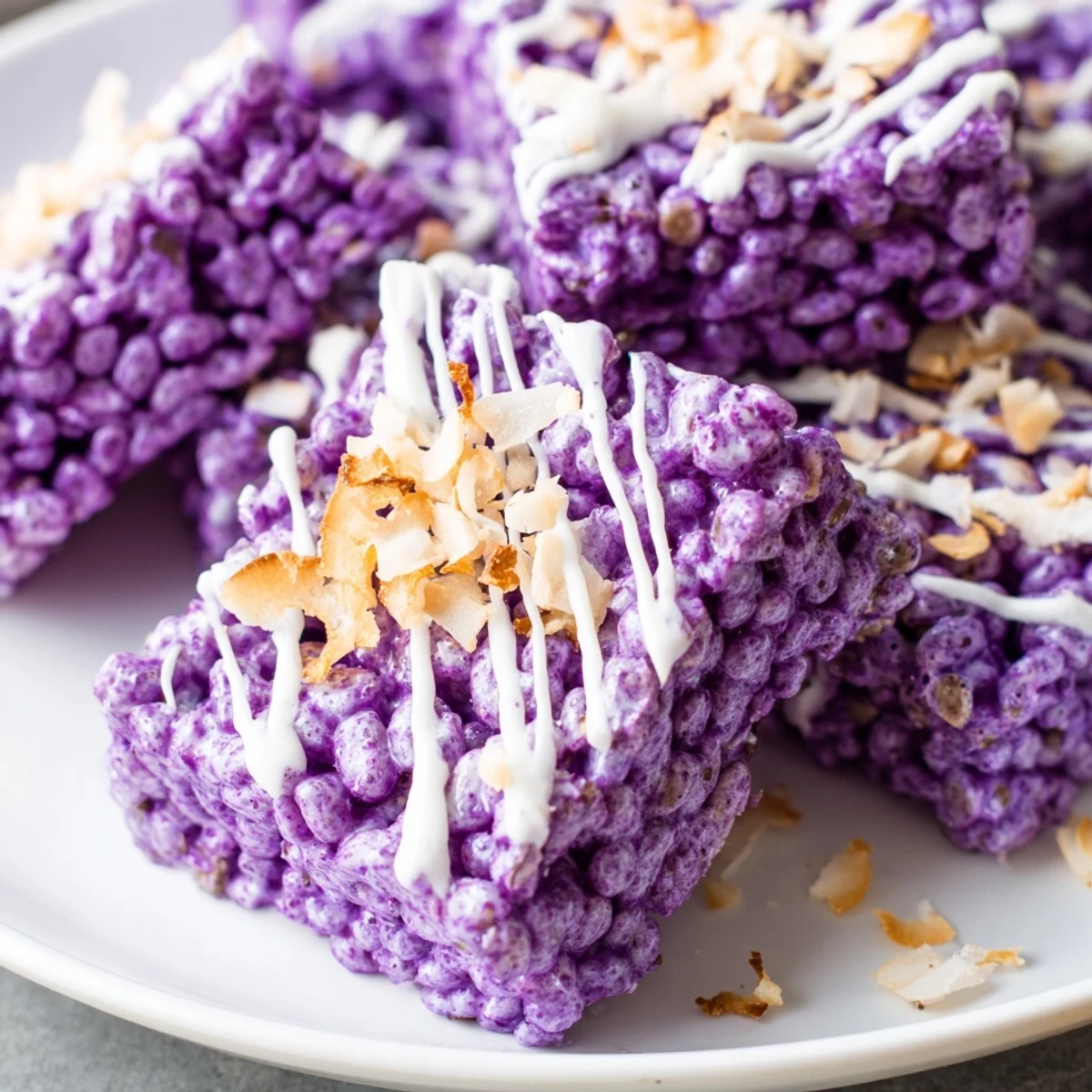 Purple yam rice krispie treats held in hand showing soft marshmallow texture and vibrant color