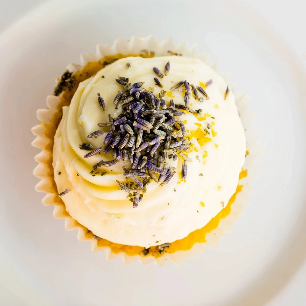 Golden lemon lavender cupcakes with zesty citrus flavor and floral notes on a white plate