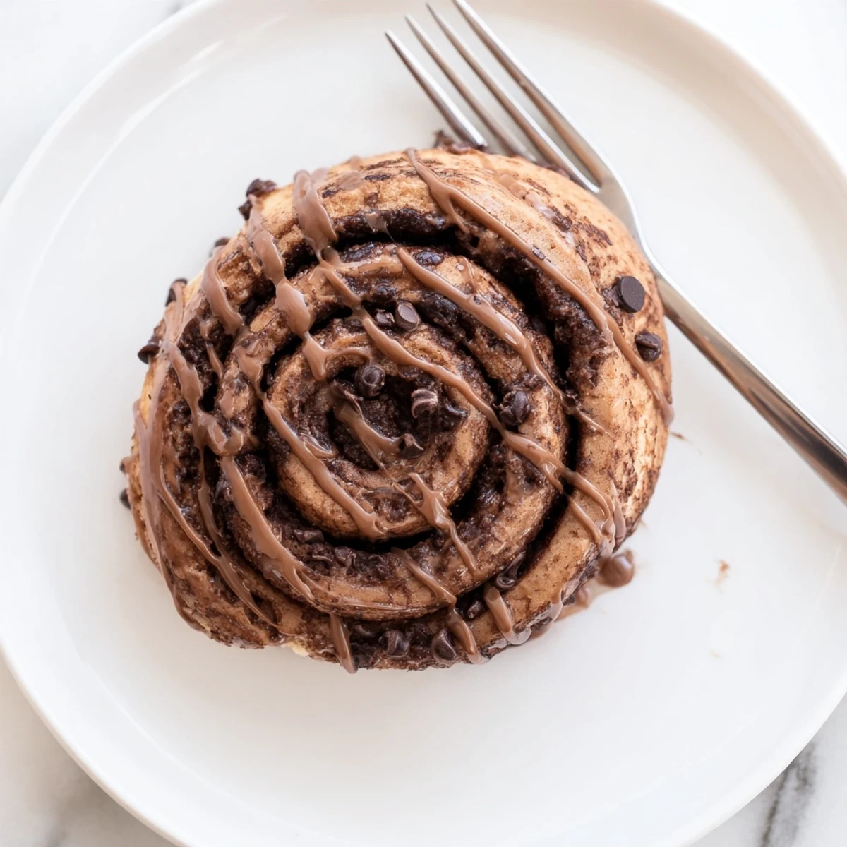 Freshly baked Double Chocolate Cinnamon Rolls with glossy chocolate glaze dripping down the spiraled sides