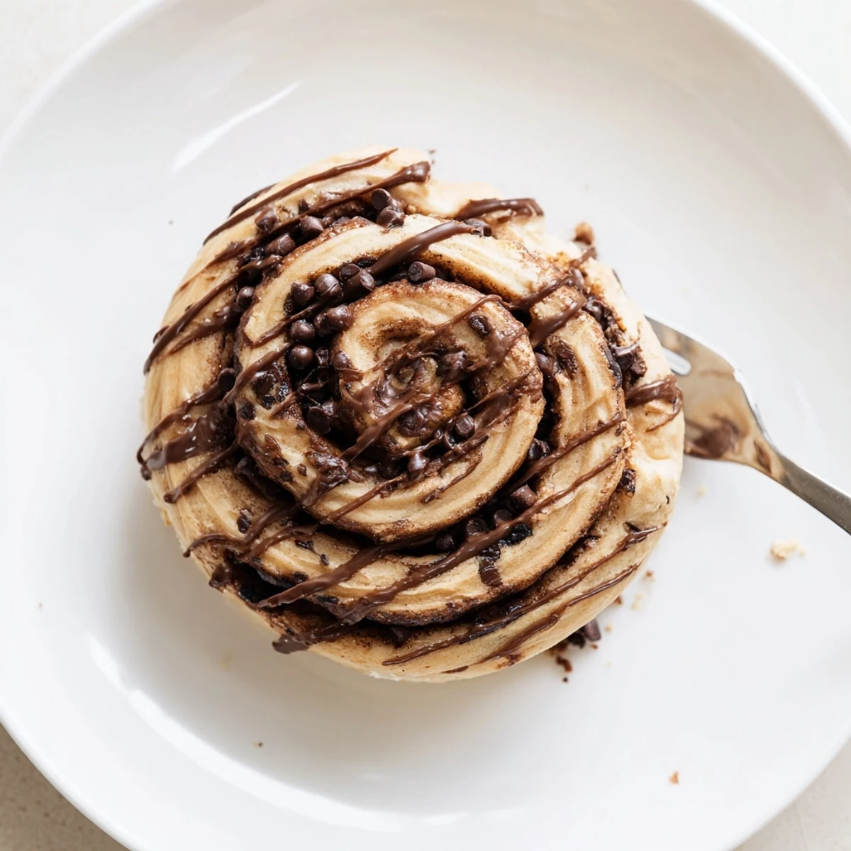 Soft chocolate-swirled Double Chocolate Cinnamon Rolls cooling in a baking pan with rich fudge frosting