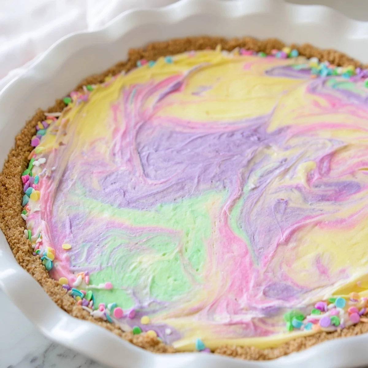 Creamy Easter Swirl Pie featuring marbled pastel colors on a crisp graham cracker base