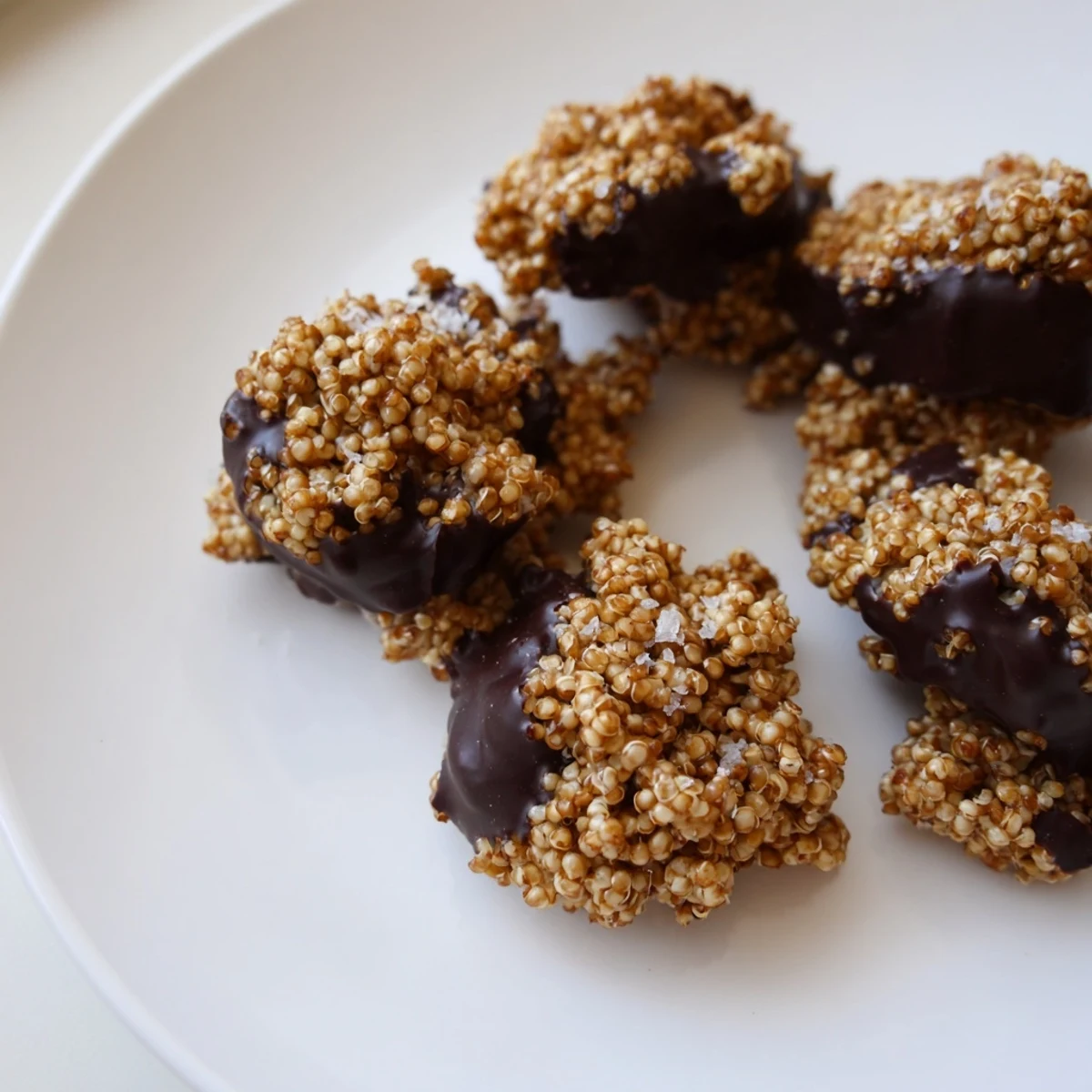 Rich melted dark chocolate coats toasted crunchy quinoa in these crisp round treats