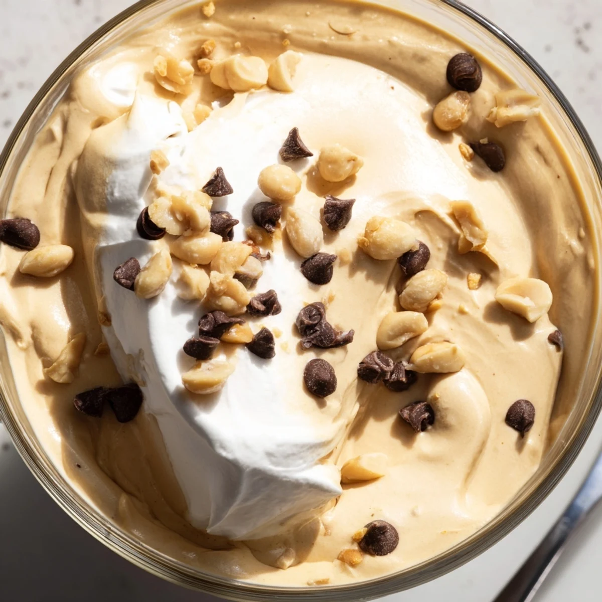 Fluffy no-bake peanut butter mousse topped with roasted peanuts and mini chocolate chips