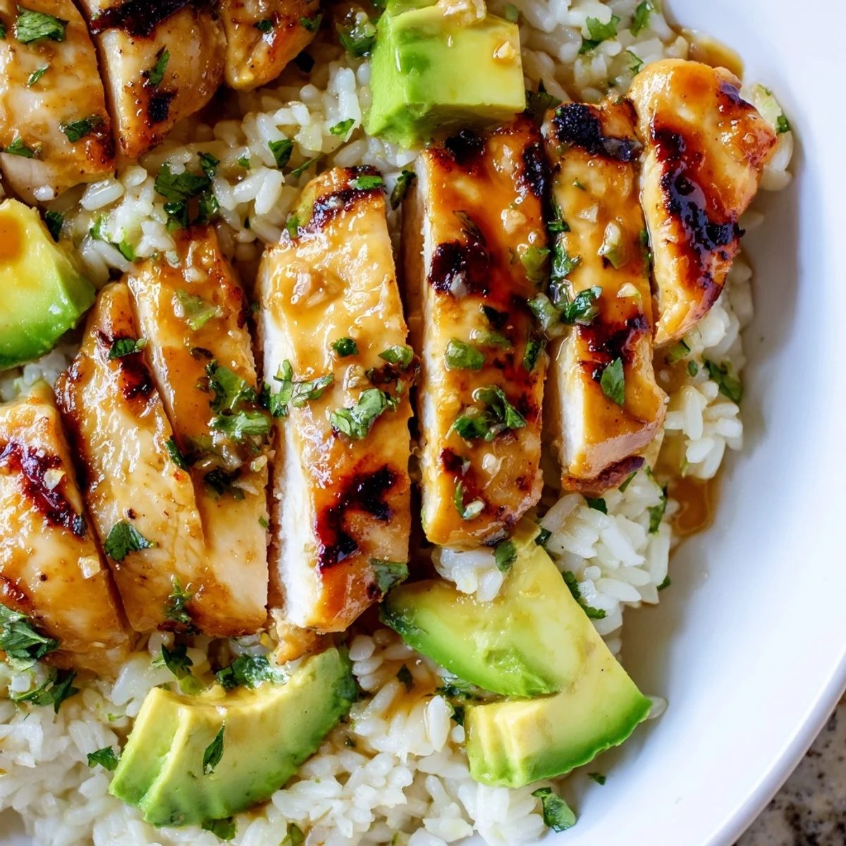Tender glazed honey lime chicken plated alongside fluffy avocado rice studded with diced avocado and herbs
