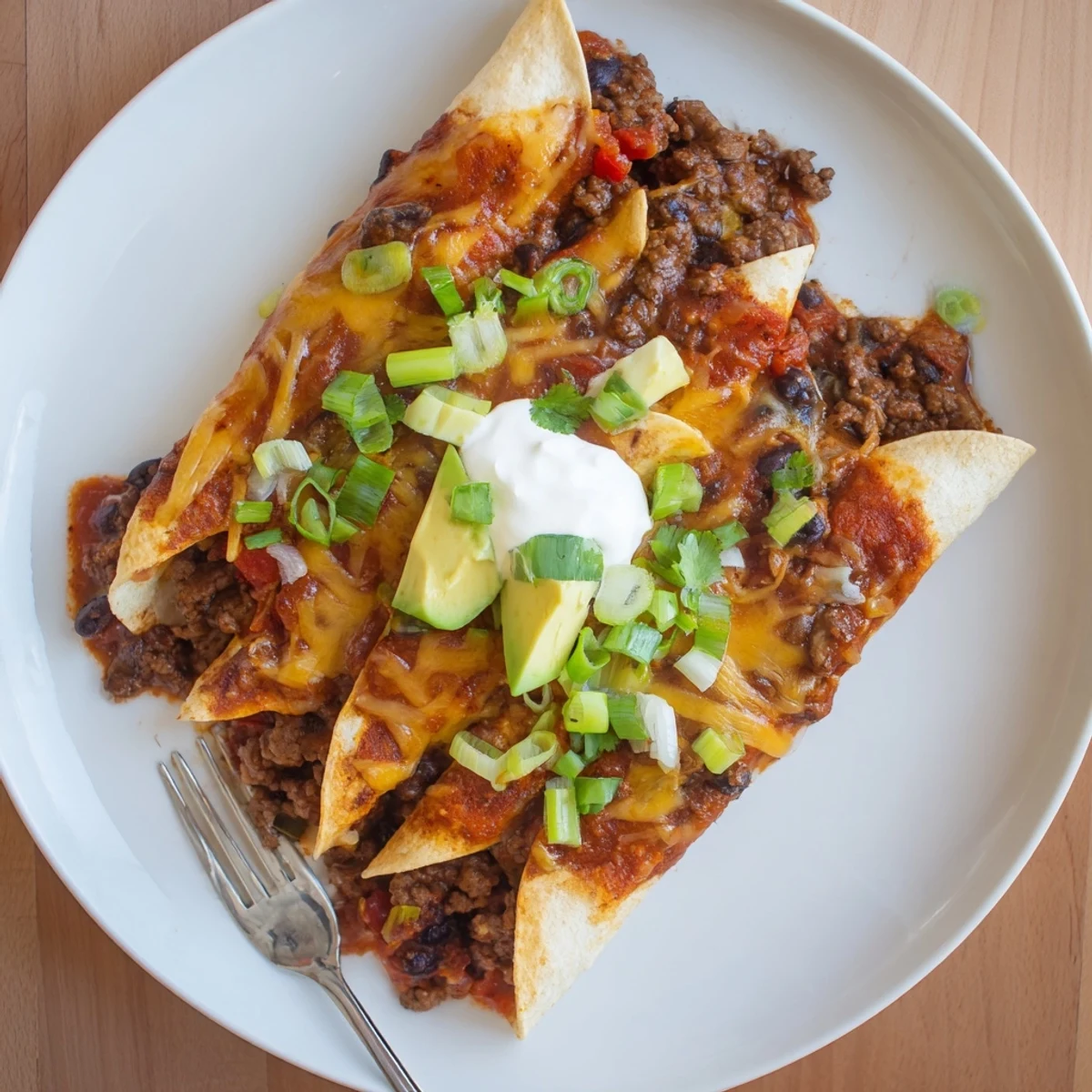 Smoky Beef Skillet Enchiladas layered with corn tortillas, black beans, zesty sauce