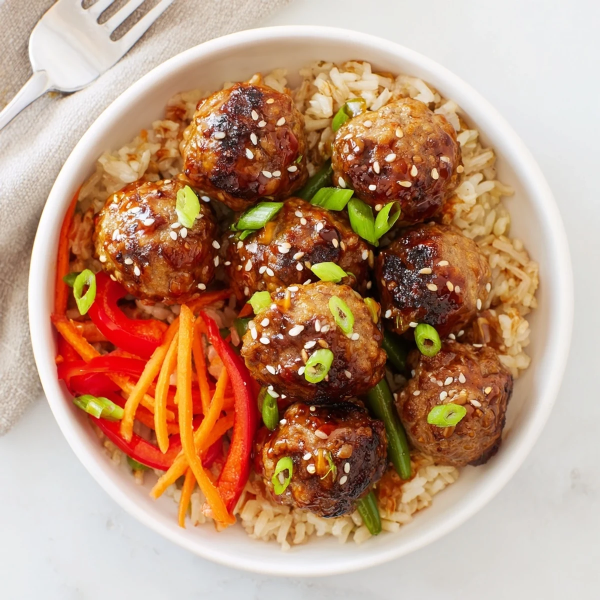 Hello Fresh Firecracker Meatballs glazed and steaming over fluffy jasmine rice, scallions