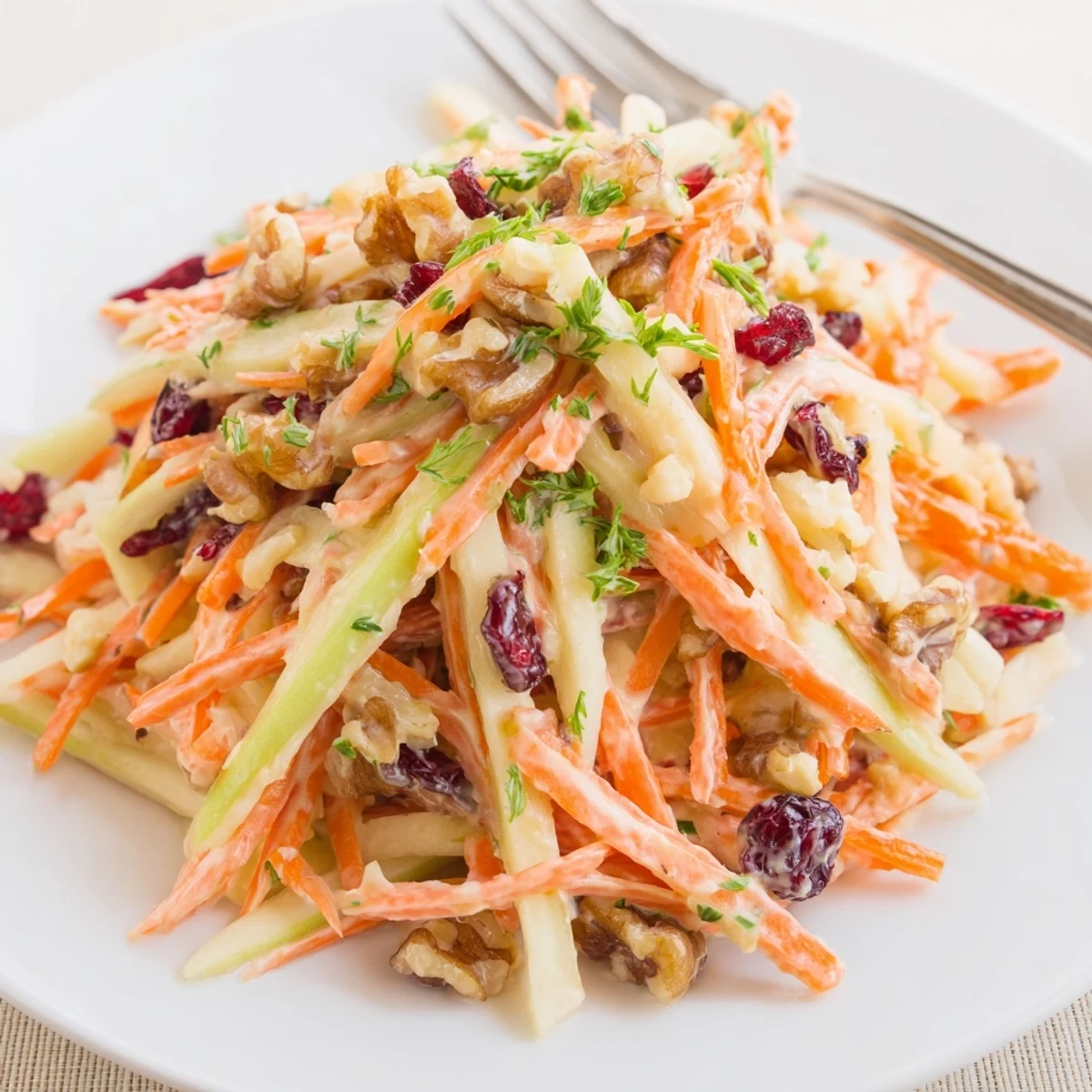 Crunchy Apple Carrot Salad With Creamy Citrus Dressing, tossed with toasted walnuts.