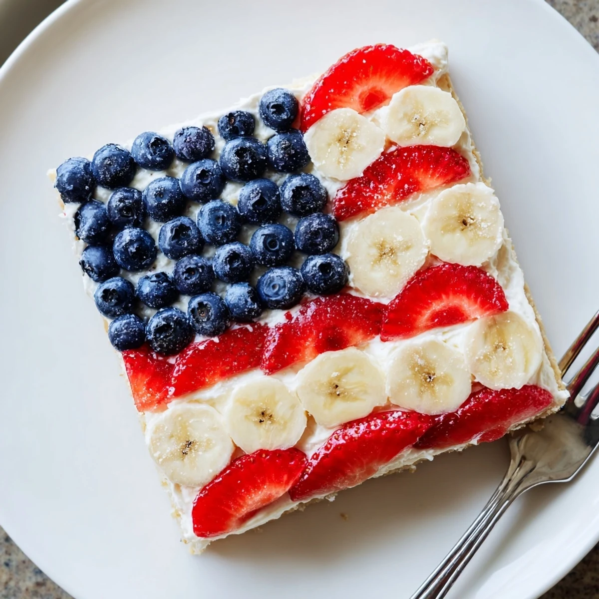 American Flag Fruit Pizza on a cooling rack, glossy berries and creamy frosting