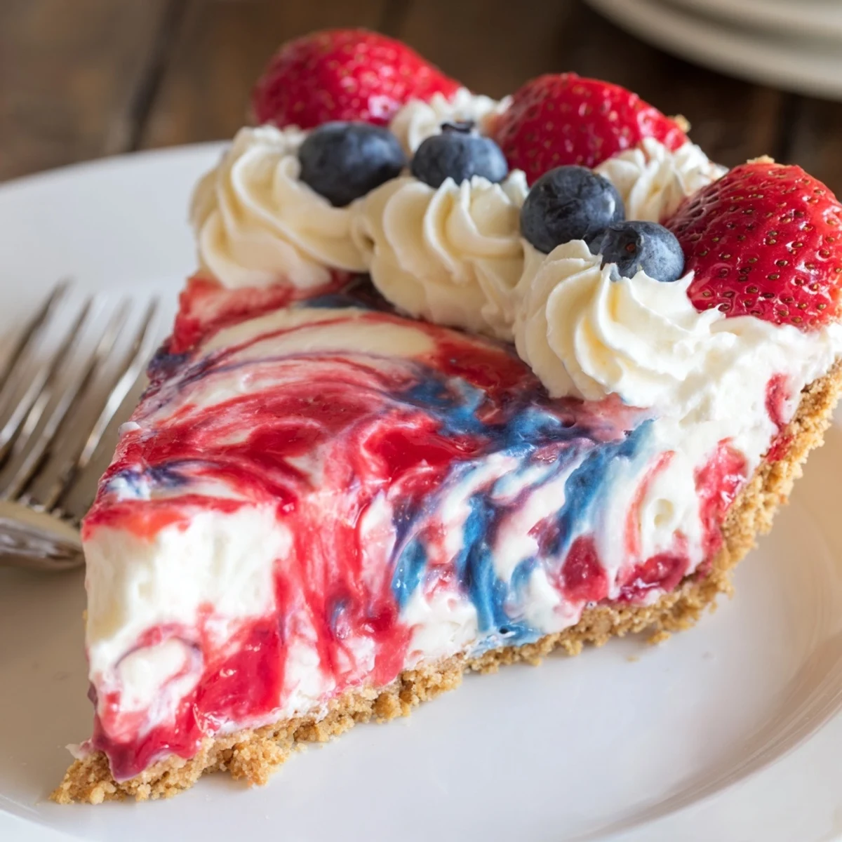 Patriotic Red White And Blue Swirl Pie with glossy swirls and fresh berries