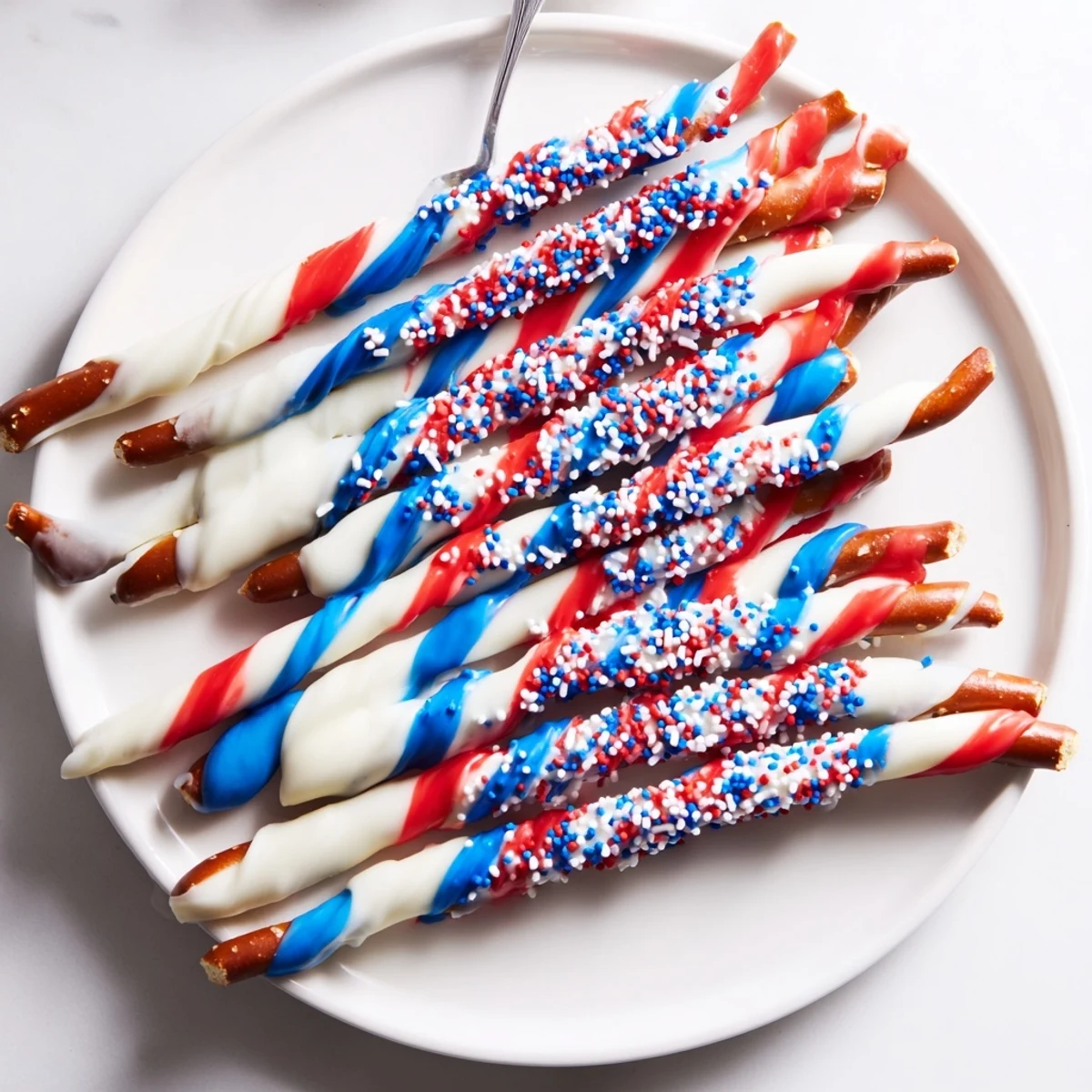 Chilled Patriotic Pretzel Rods arranged on parchment, ideal for Fourth of July