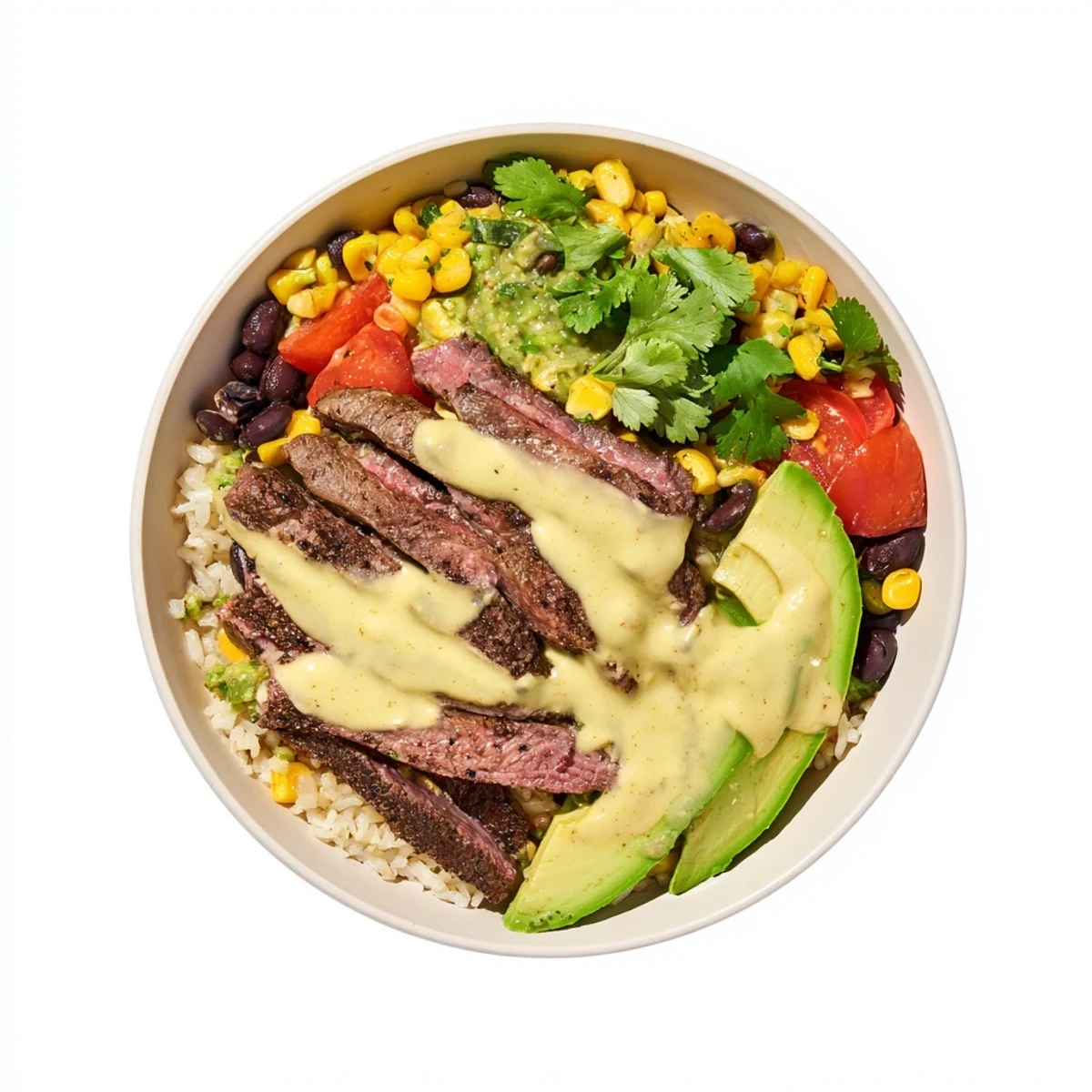 Hearty steak queso rice bowl topped with black beans avocado tomatoes and golden cheese sauce