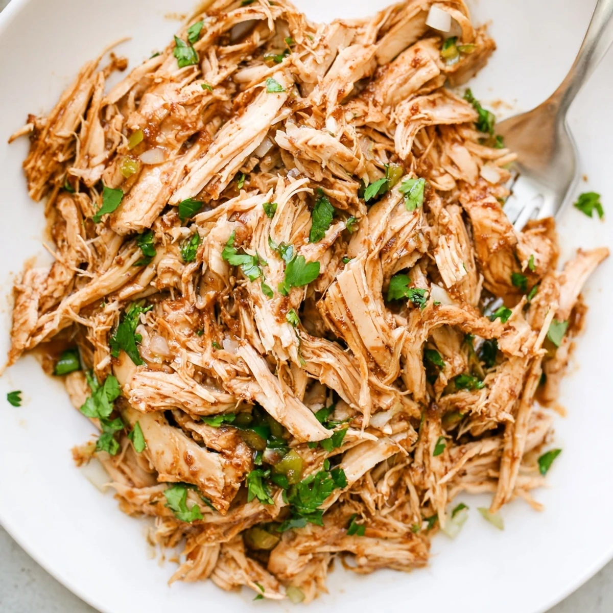 Slow Cooker Cilantro Lime Chicken shredded and juicy, garnished with fresh lime  