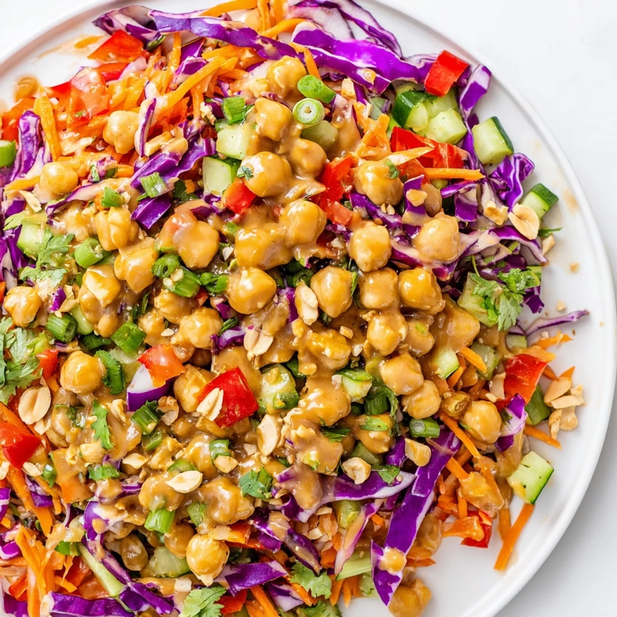 Crunchy Thai chickpea salad loaded with purple cabbage carrots and zesty peanut dressing