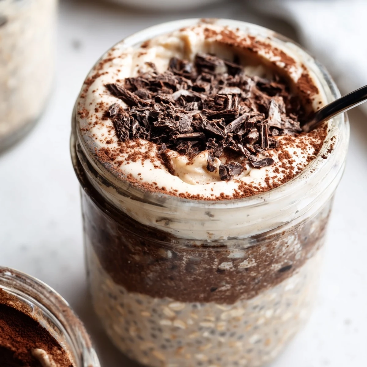 Tiramisu overnight oats topped with velvety mascarpone and dark chocolate shavings