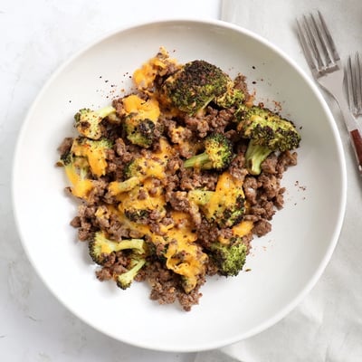 A low-carb dinner idea with sizzling beef, tender veggies, and creamy cheese, plated for an easy weeknight meal.