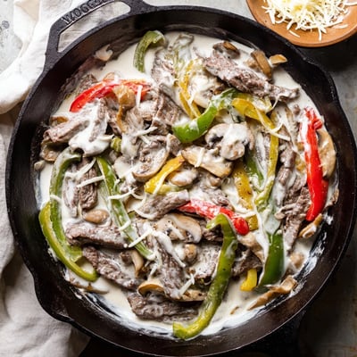 Sizzling ribeye steak mixed with melted provolone and mushrooms in this creamy Keto Philly Cheesesteak Skillet, ready to serve.
