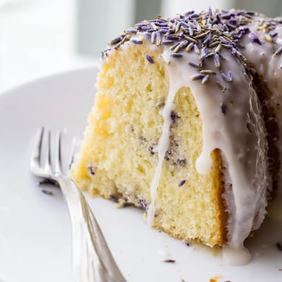 Freshly baked Lemon Lavender Cake with visible lavender buds and lemon zest, ready to serve at a family gathering.