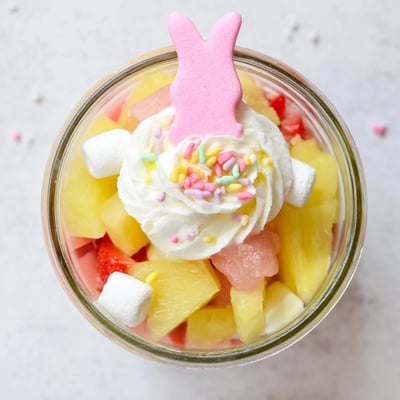 Individual Jello Pie Easter Bunny Parfait In A Jar desserts showcase strawberry and lemon gelatin cubes with fluffy whipped cream.