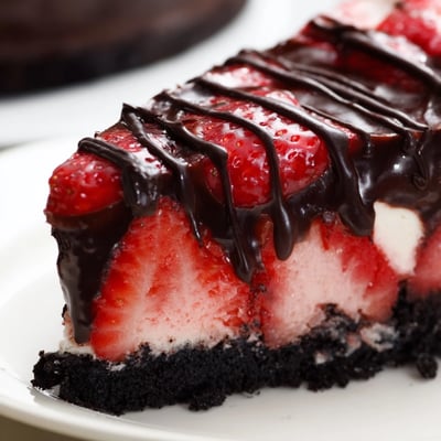 This decadent Chocolate Covered Strawberry Cheesecake features a chocolate cookie crust, silky strawberry filling, and dark chocolate drizzle.