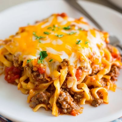 Skillet to oven Beef Noodle Casserole topped with parsley, ready to serve.