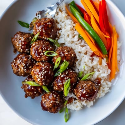 Sizzling Hello Fresh Firecracker Meatballs tossed in spicy-sweet sauce beside crisp vegetables